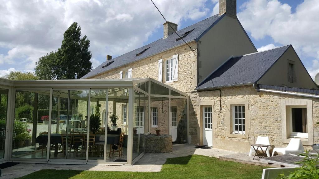 an extension to a house with glass doors at La Drorie in Crouay