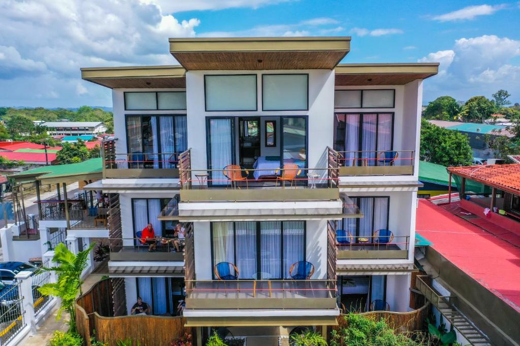 a house with balconies on a building at La Fortuna Lodge by Treebu Hotels in Fortuna