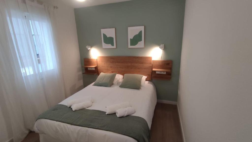 a bedroom with a large white bed with two pillows at Acogedor apt en casco historico in Marbella