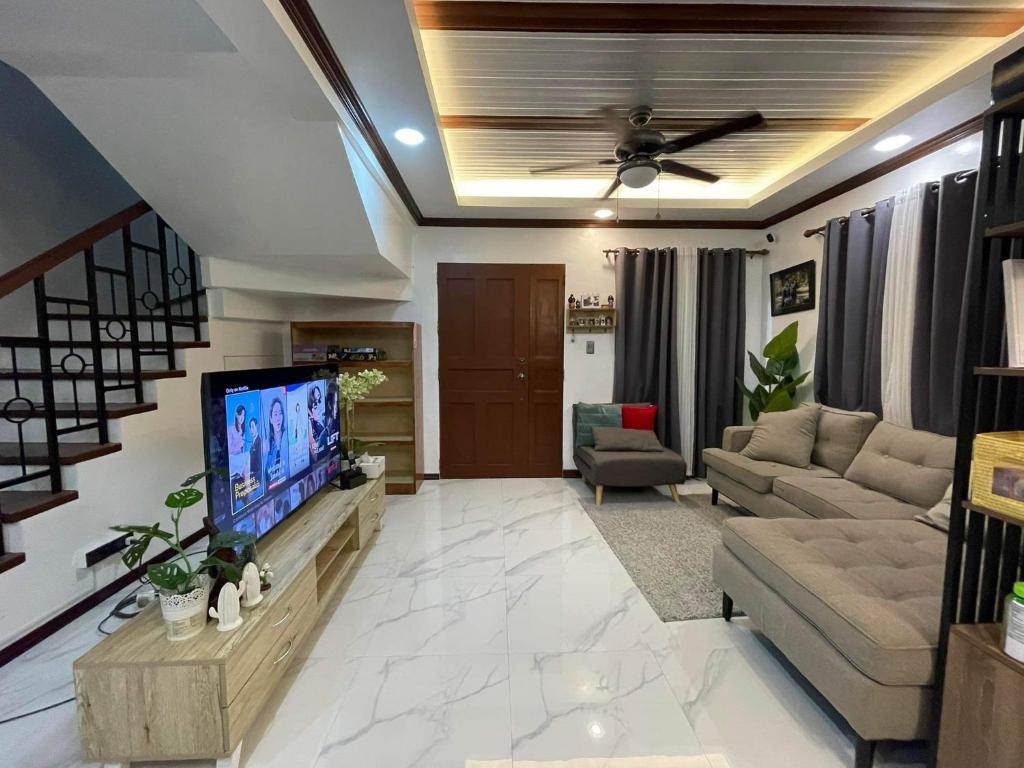 a large living room with a flat screen tv at Camella Cerritos Gensan in General Santos