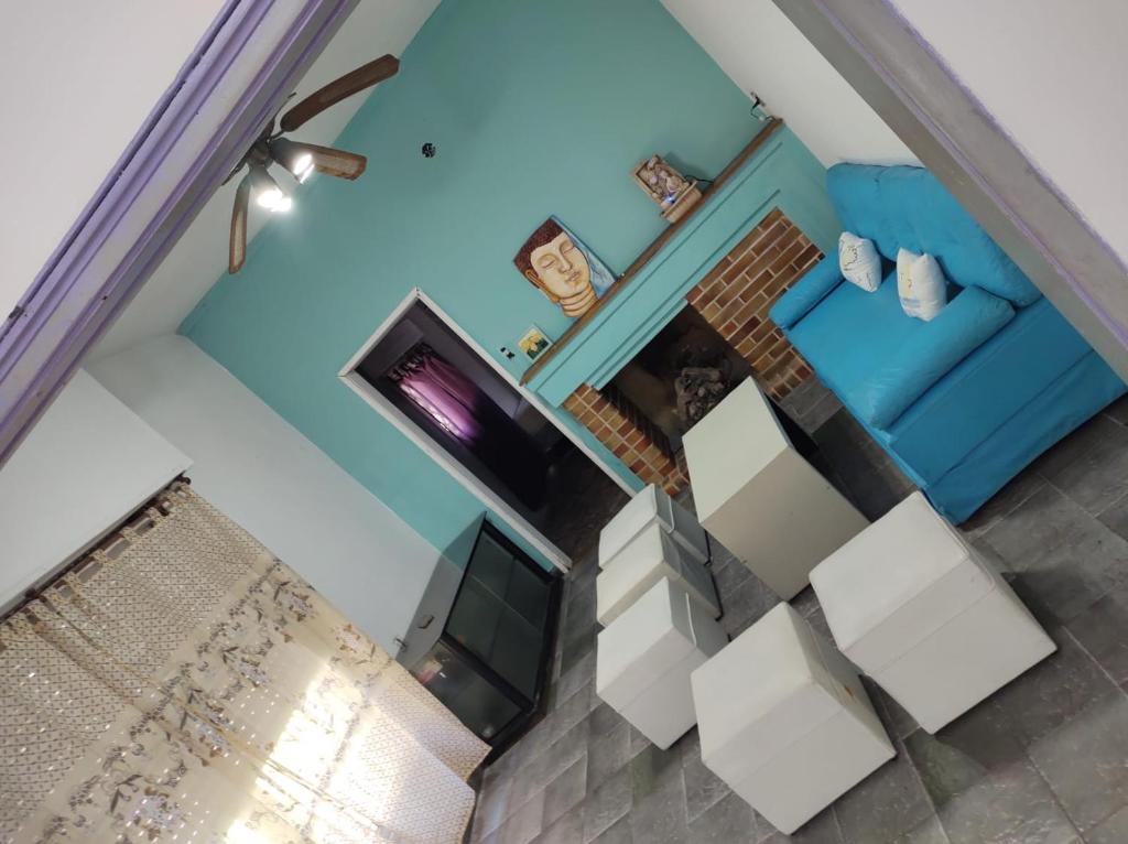 an overhead view of a living room with a blue couch at Dakini Hostel in Lomas de Zamora