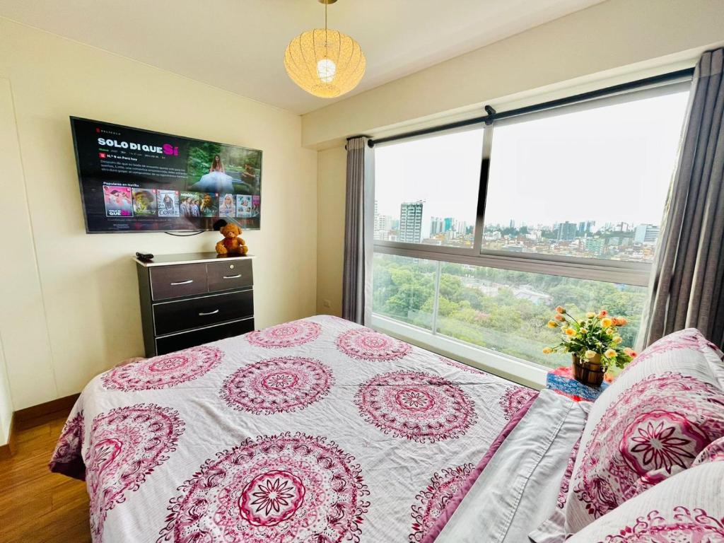 a bedroom with a bed and a large window at Habitaciones CASTILLA in Lima