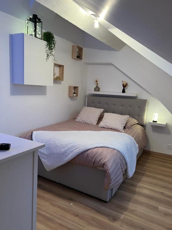 1 dormitorio con 1 cama grande en el ático en Le Concon Versaillais, à 5 minutes du Château de Versailles, en Le Chesnay