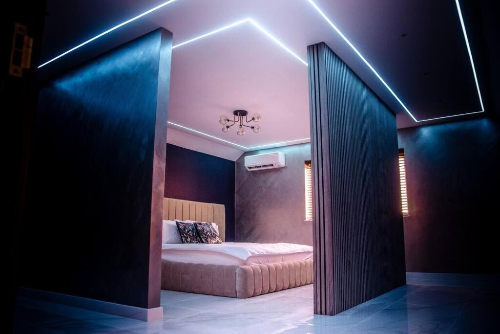 a bedroom with a bed in a room with lights at Luxury City Stay: 2-BR Penthouse in Wolverhampton