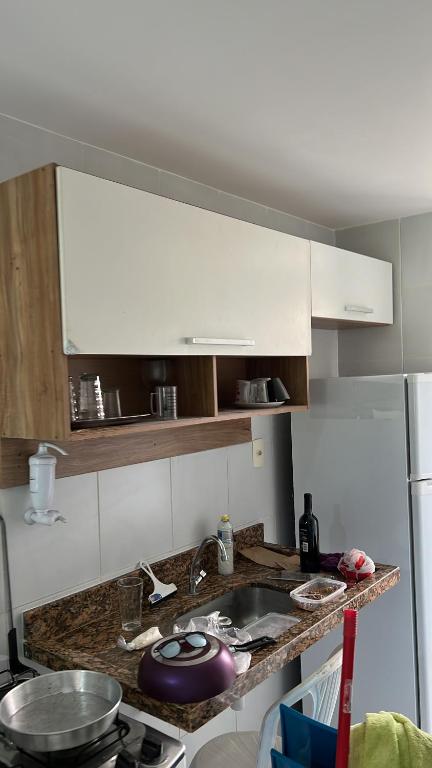 a kitchen with a sink and a counter top at Condominio reserva imbassai in Mata de Sao Joao