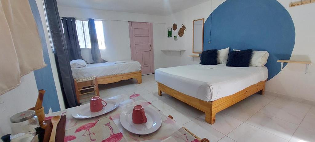 a small bedroom with a bed and a mirror at Apto Los Blancos, a dos Minuto de los Patos in Bejuquero