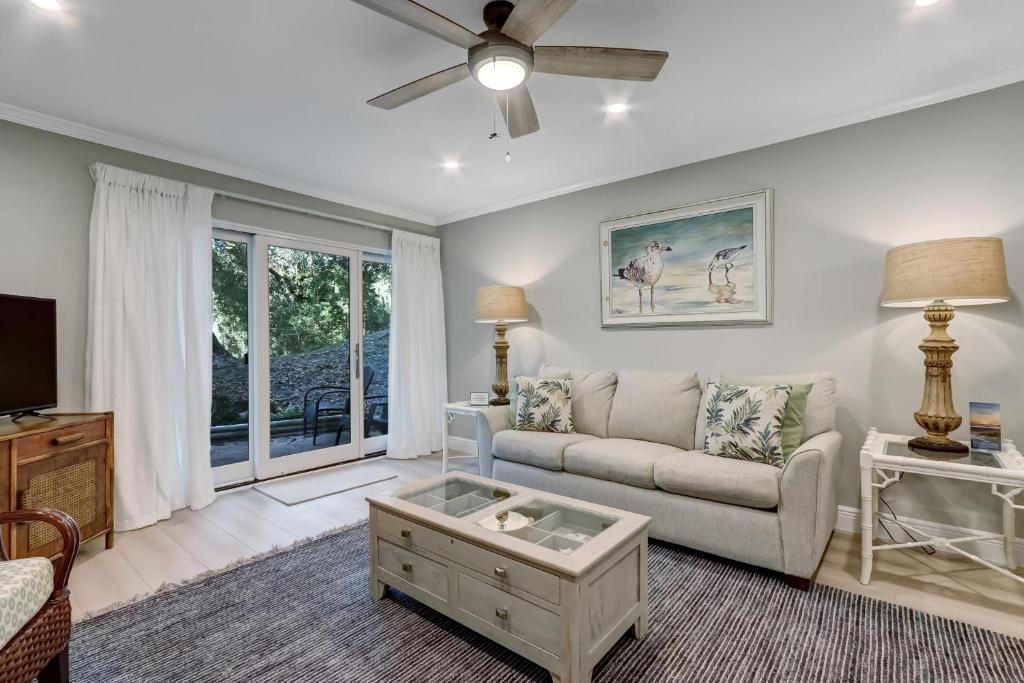 a living room with a couch and a tv at 2107 Beach Wood in Amelia Island
