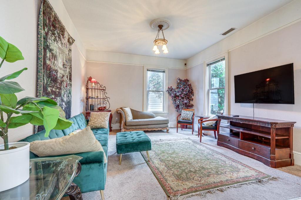 a living room with a tv and a piano at Eclectic Sacramento Home about Half Mi to Downtown! in Sacramento