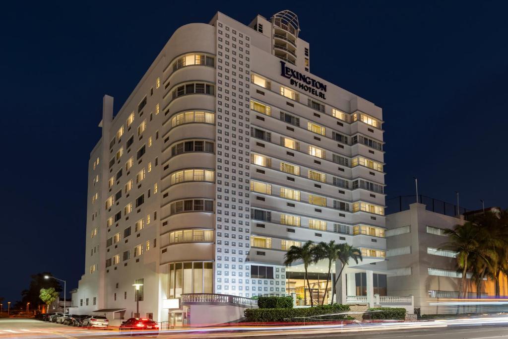 a tall white building with lights on at Lexington by Hotel RL Miami Beach in Miami Beach