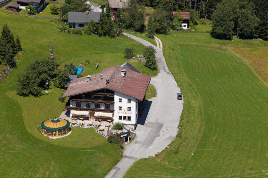 an aerial view of a large house on a green field at Salzburger Dolomitenhof in Annaberg im Lammertal