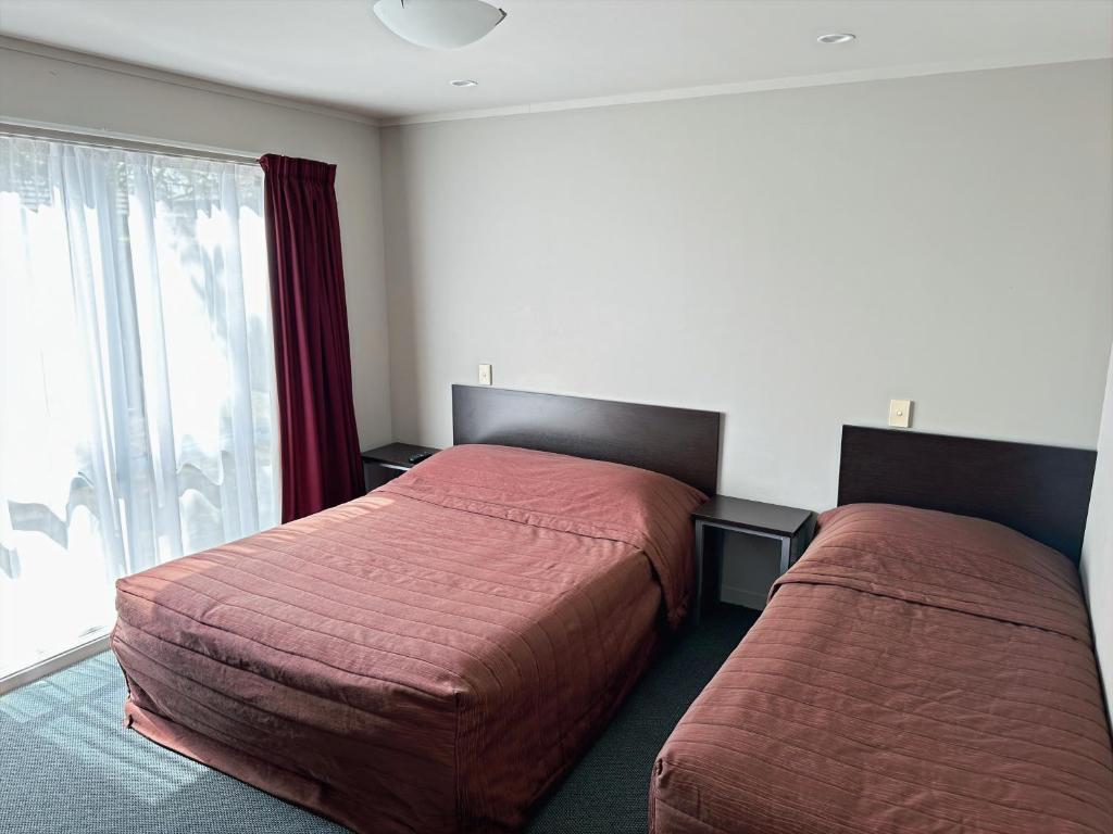 Postel nebo postele na pokoji v ubytování Arena Lodge