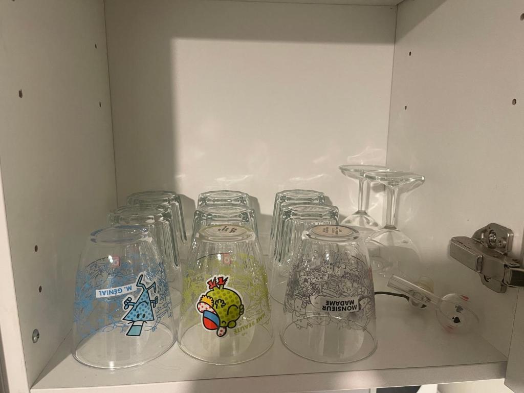 a shelf with several glass clocl jars on it at T4 spacieux tout confort &#47; parking gratuit in Grenoble