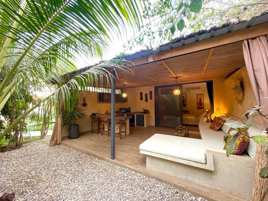 a living room with a couch and a table at Villa YEMAYA - Suite bungalow indépendant in Ngaparou