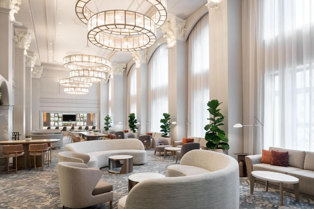 a lobby with chairs and tables and a chandelier at The Westin Book Cadillac Detroit in Detroit