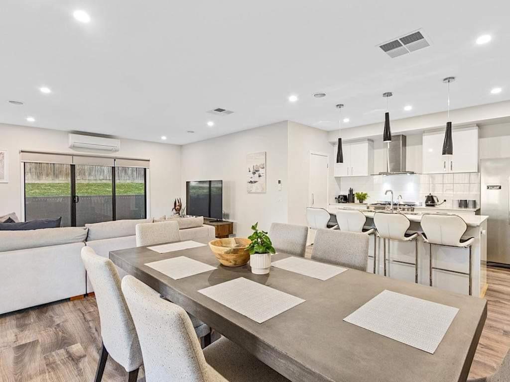 a kitchen and living room with a table and chairs at 11a Railway Parade Wandin North in Wandin North
