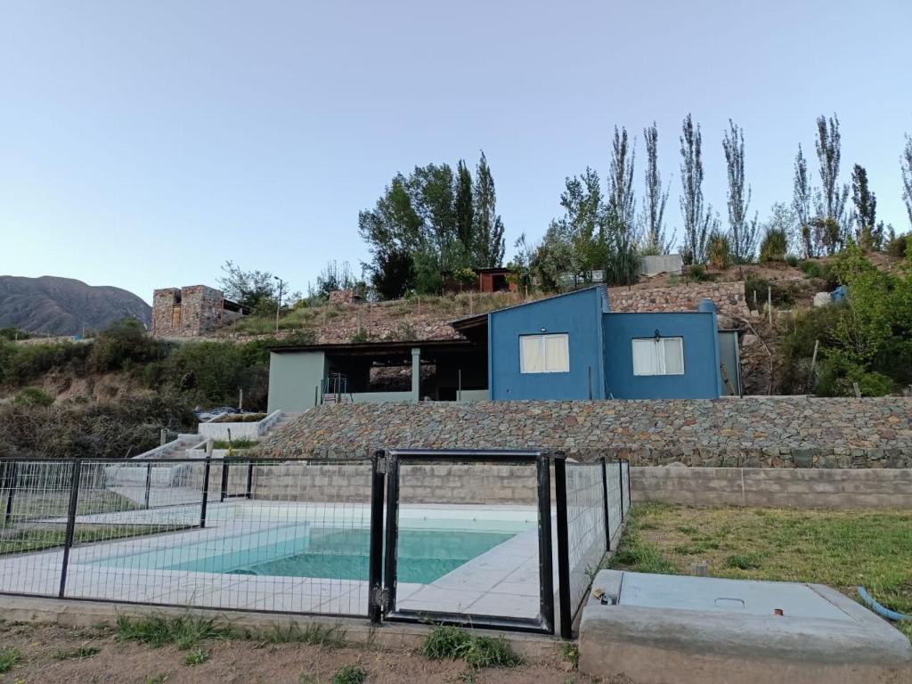 a tennis court in front of a house at Mendoza, Cacheuta, montaña in Ciudad Lujan de Cuyo