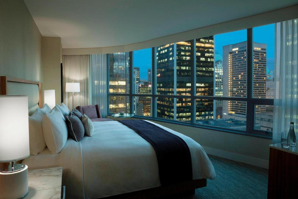 a hotel room with a large bed and a large window at Vancouver Marriott Pinnacle Downtown Hotel in Vancouver