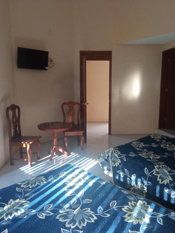 Postel nebo postele na pokoji v ubytování Hotel Lienzo Charro 1