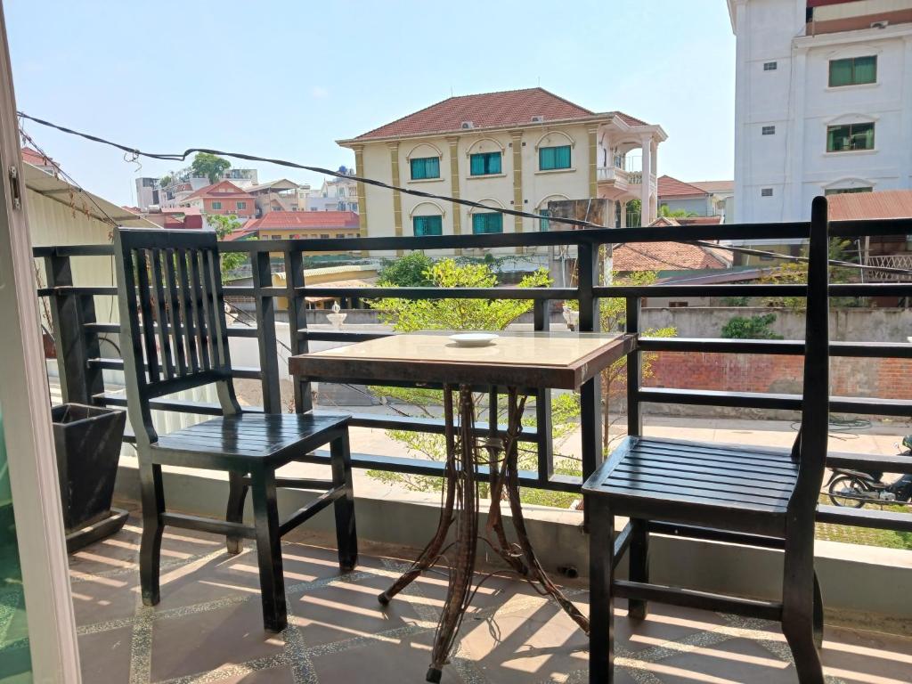 a table and two chairs on a balcony at Andy's Place in Siem Reap