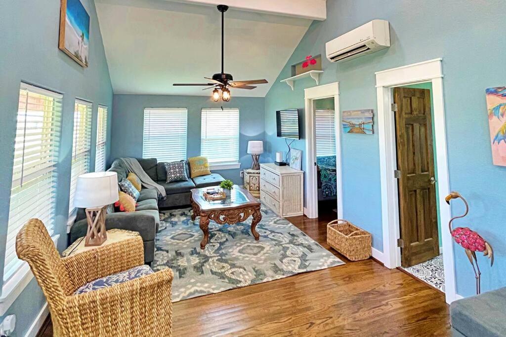 a living room with a couch and a table at The Pink Flamingo Beach Gulf views in Freeport