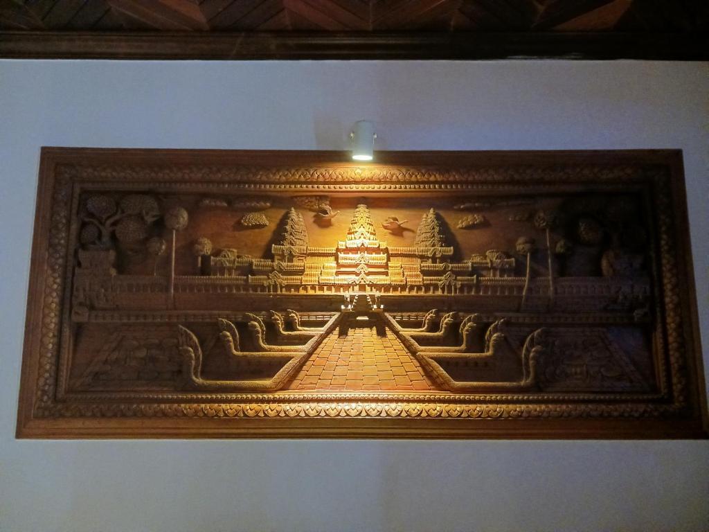 a picture of a carving of a temple at Andy's Place in Siem Reap