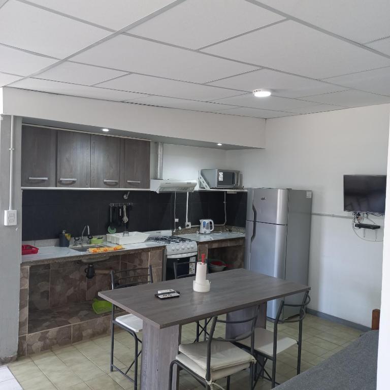 a kitchen with a table and a refrigerator at Alquiler por dia en choele. Depto 5 in Choele Choel