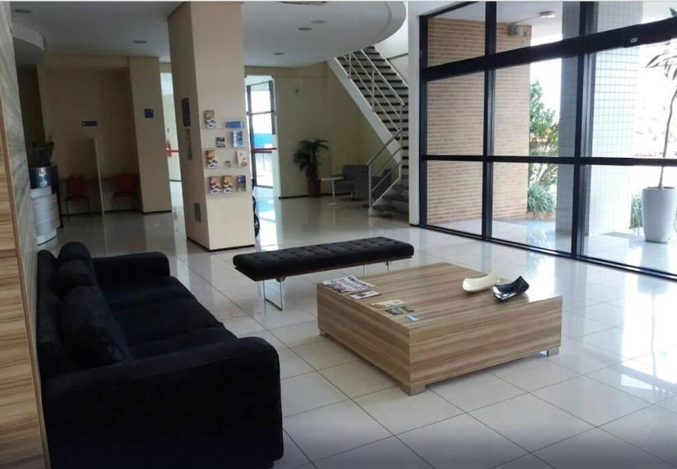 a living room with a couch and a coffee table at Flat Biarritz em São Luís com excelente localização! in São Luís