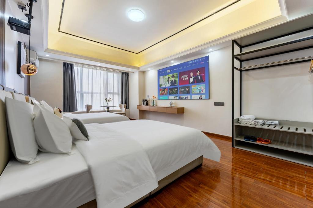 Postel nebo postele na pokoji v ubytování East Maple International Apartment - Guangzhou Luogang Wanda Plaza Suyuan Metro Station
