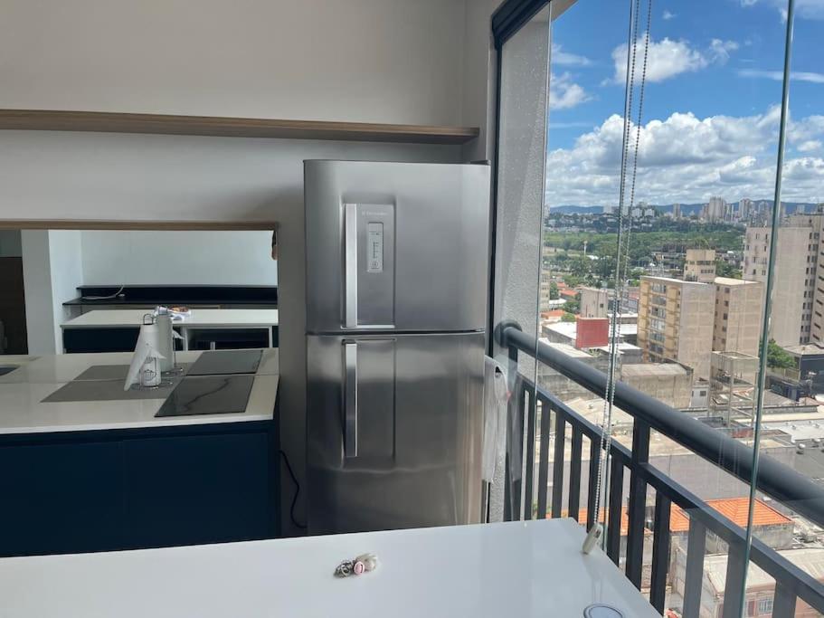 a kitchen with a stainless steel refrigerator on a balcony at Studio Amplo Linda Vista SP/Allianz/ Sambódromo in Sao Paulo