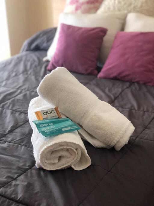 a white towel and a tube of toothpaste on a bed at Departamento Villa crespo I in Buenos Aires