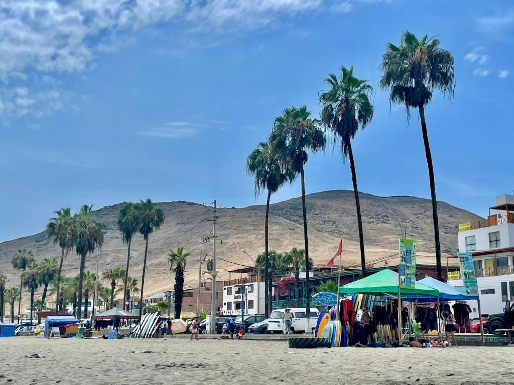 una spiaggia con palme e una montagna sullo sfondo di La Casa Roja Cerro Azul a Cerro Azul