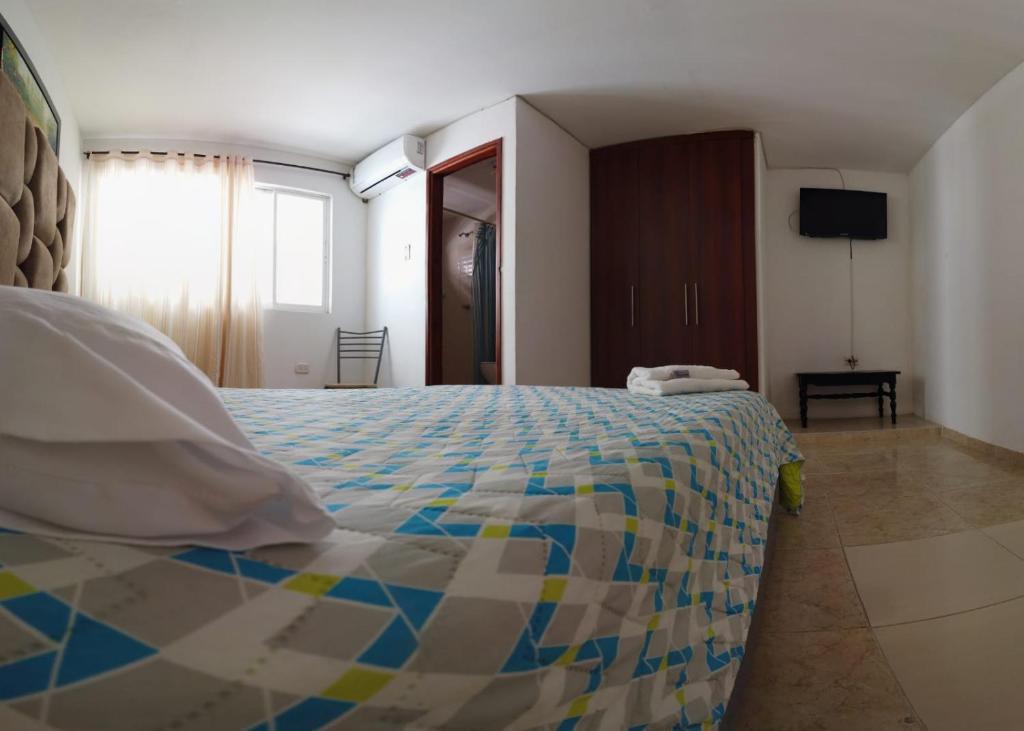 Postel nebo postele na pokoji v ubytování Hotel Sierra Nevada B&B SAS