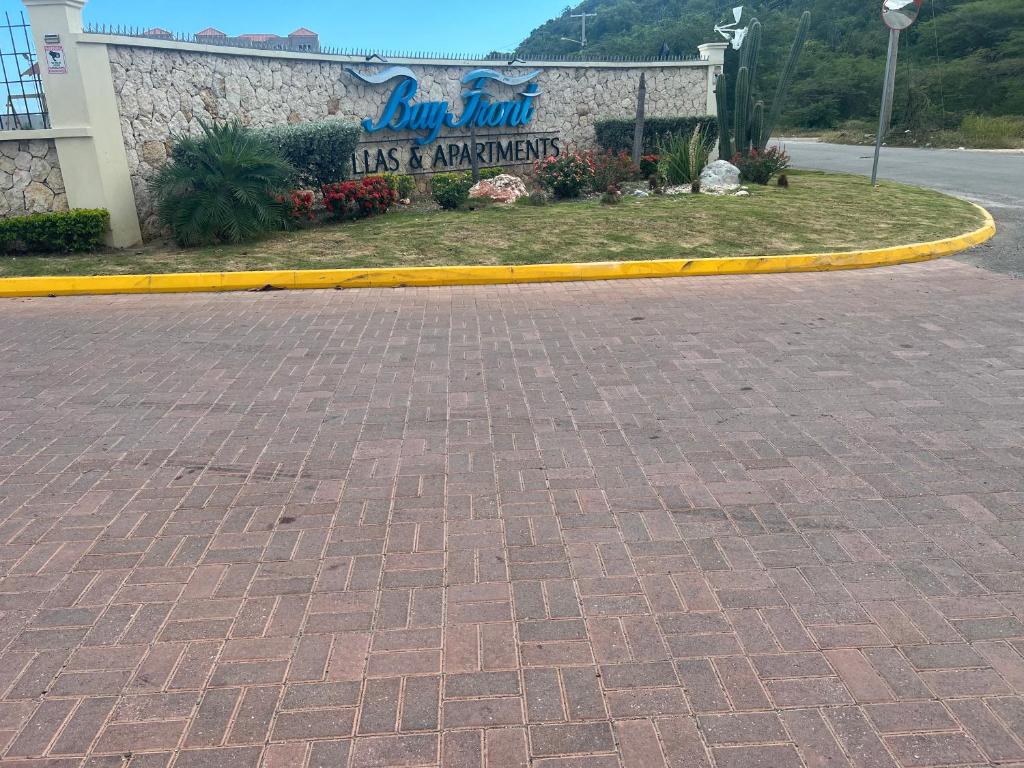 a sign for a los angeles airport with a brick driveway at Beach access apartment in Portmore