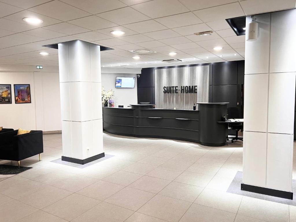 an office lobby with a smile phone sign on the wall at Suite Home Briancon Serre Chevalier in Briançon