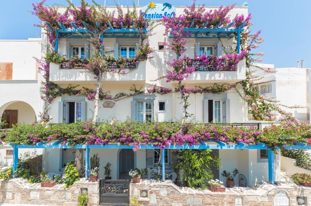 a building with flowers on the side of it at Sofi pension in Naxos Chora