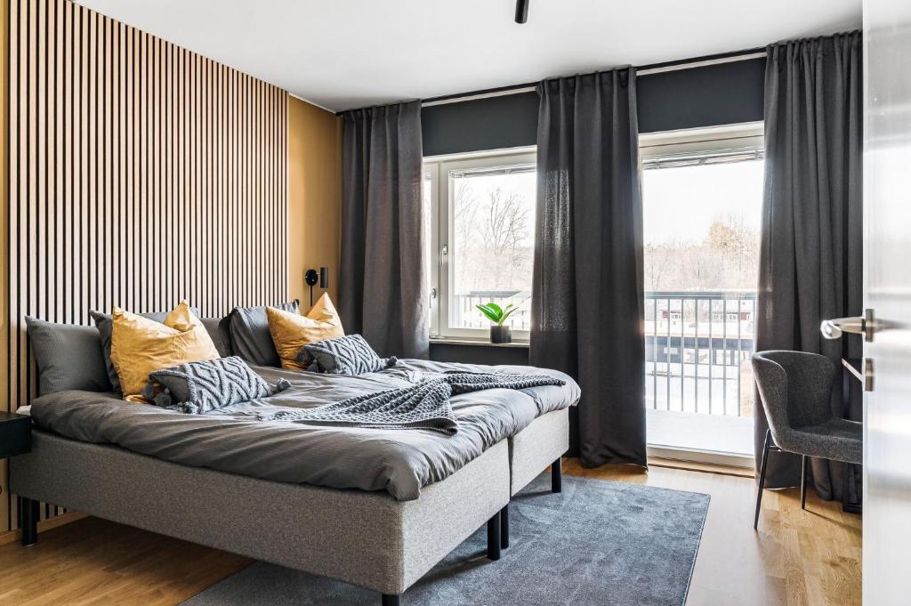 a bedroom with a large bed in front of a window at Elite Business Suite in Nyköping