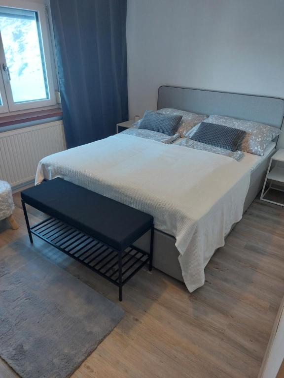 a bedroom with a large bed with a black table at Ferienhaus Frankenmarkt in Frankenmarkt