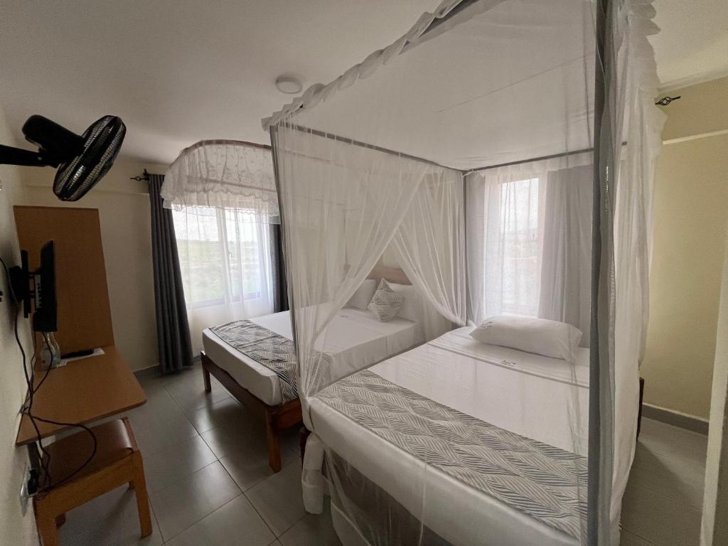 Postel nebo postele na pokoji v ubytování The Avid Hotel