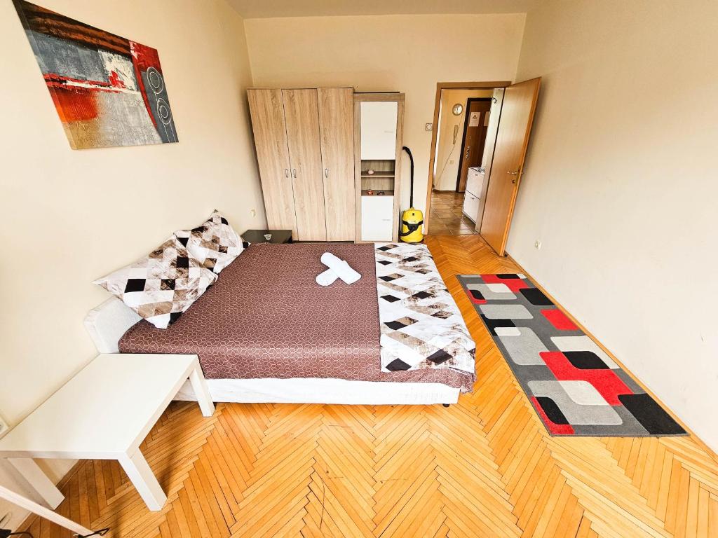 a small bedroom with a bed in a room at Exclusive Apartment Main Square in Skopje