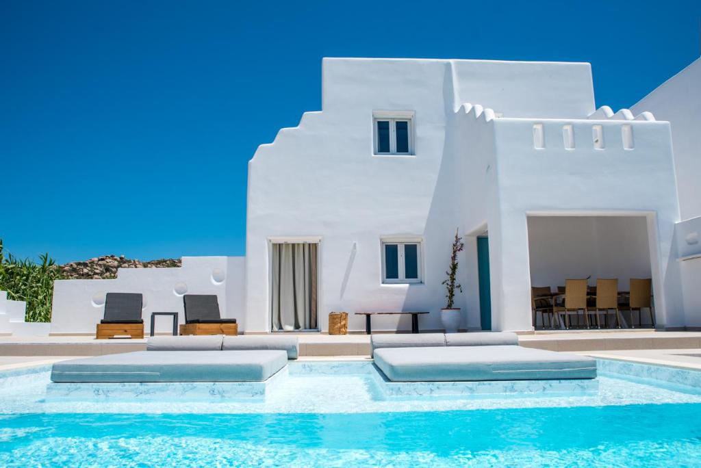 a villa with a swimming pool in front of a house at Depis Edem private villas naxos in Plaka