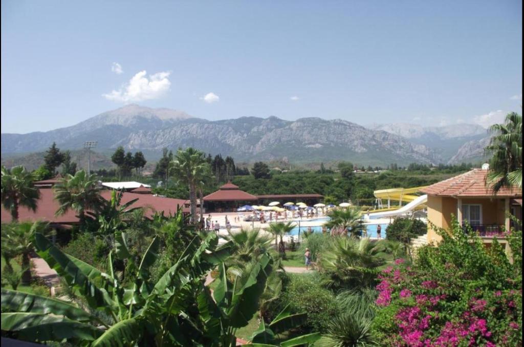 a view of a resort with mountains in the background at MIR'AMOR GARDEN Resort Hotel-ALL INCLUSIVE in Antalya