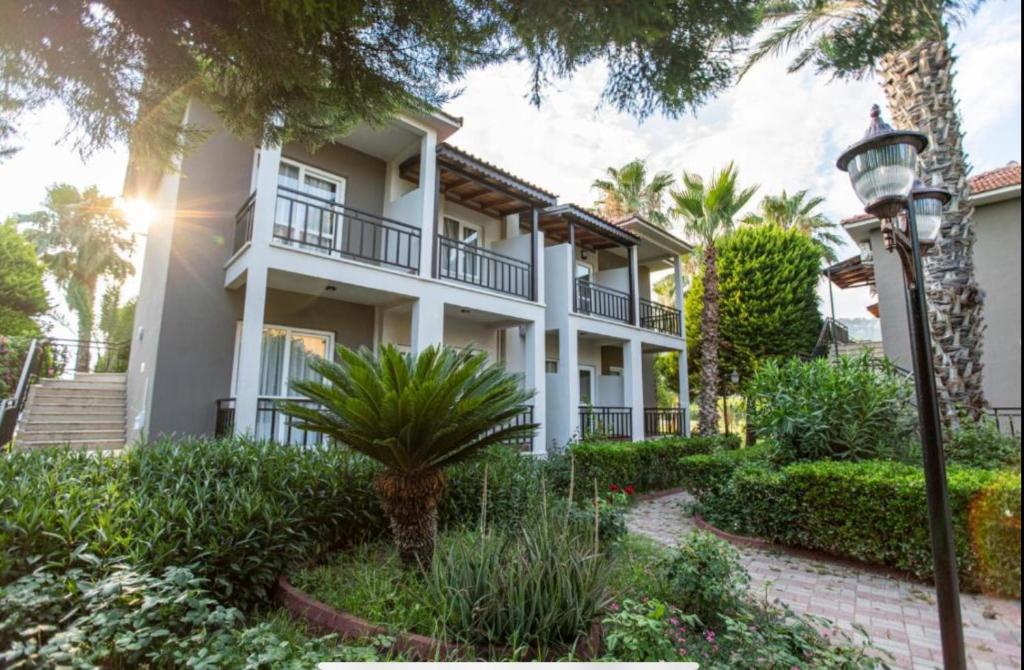 a large white house with trees and plants at MIR'AMOR GARDEN Resort Hotel-ALL INCLUSIVE in Antalya