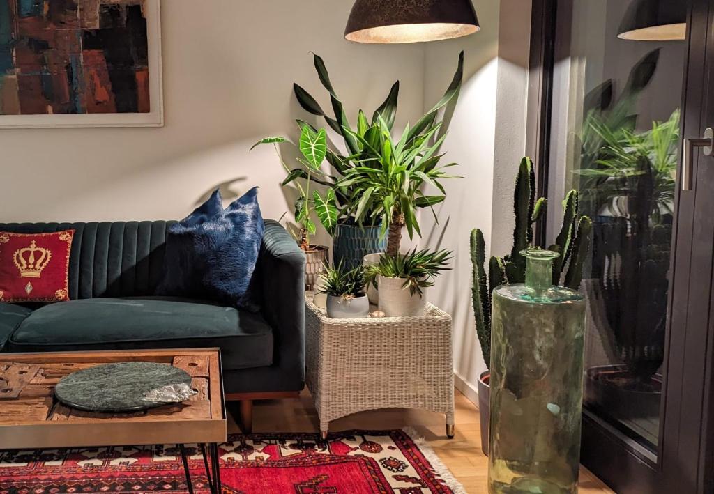 a living room with a couch and potted plants at Luxury, Spacious, Sunny home in the heart of Berlin in Berlin