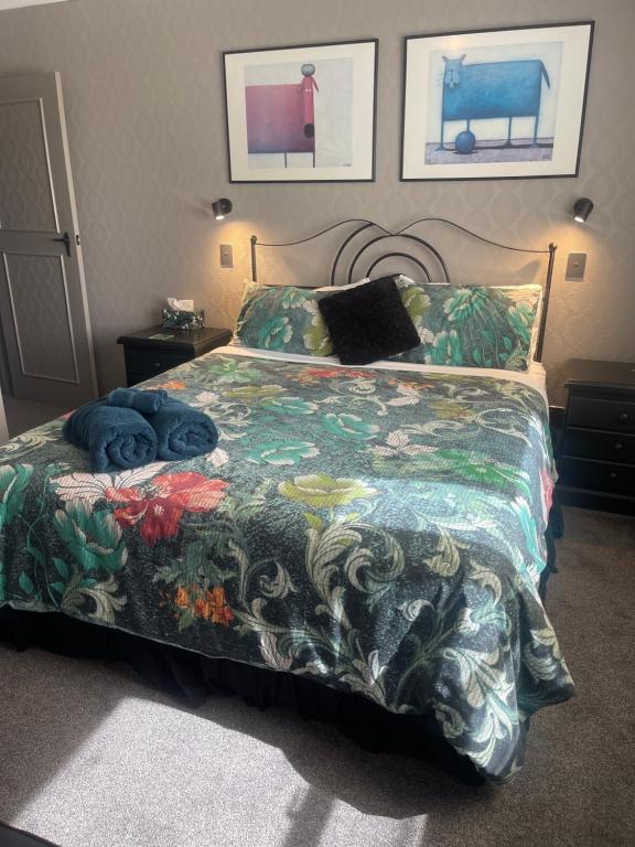 a bedroom with a bed with a colorful comforter at The Belfry in Taupo