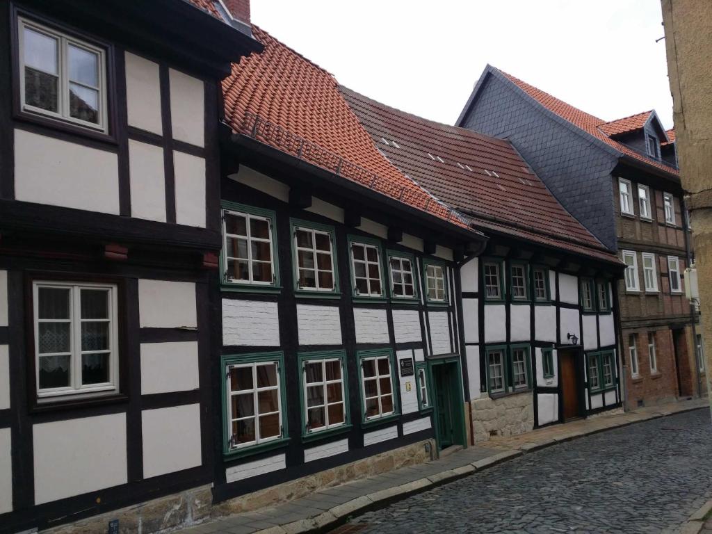 a row of black and white buildings on a street at Ferienwohnung im ältesten Fachwerkhaus in Blankenburg