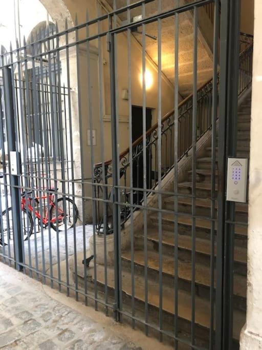 a metal gate with a staircase in a building at Le petit Opéra in Lyon