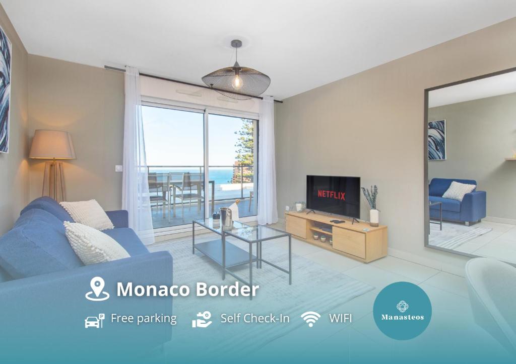 een woonkamer met een blauwe bank en een tv bij Luxury apartment - Sea View - Private parking in Beausoleil