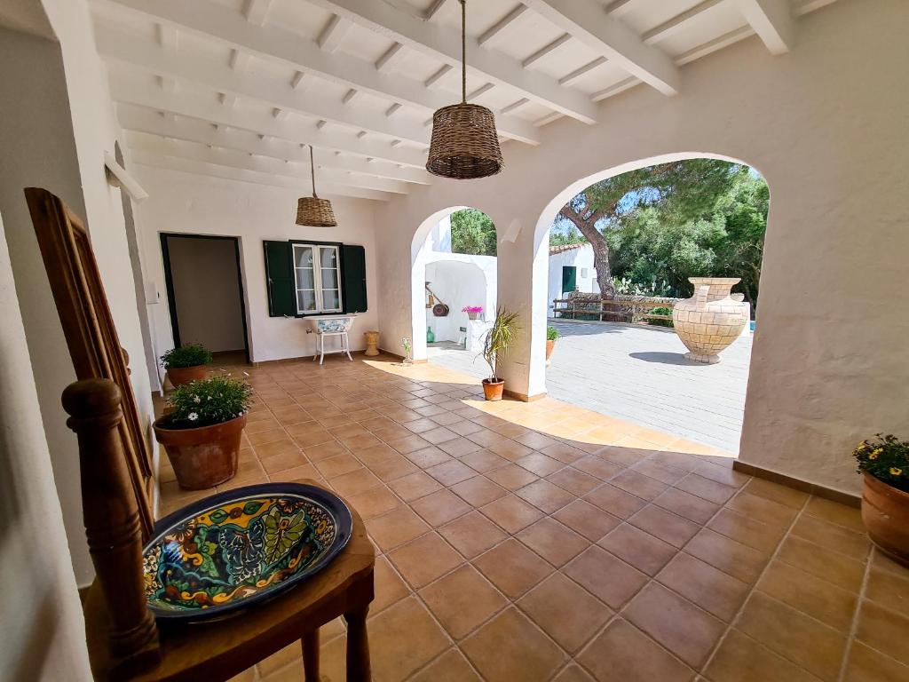 a large living room with a tile floor and an archway at Agroturismo Santa Mariana in Alaior