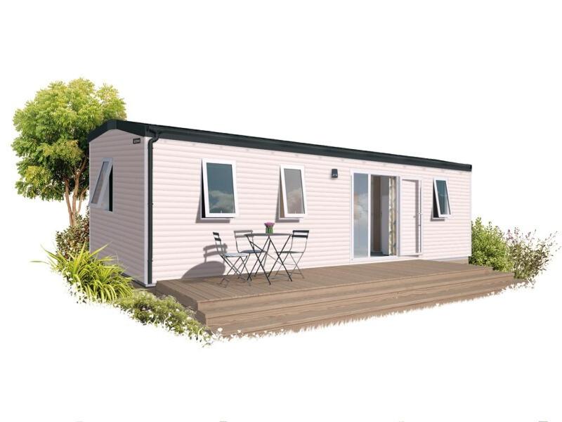 a tiny house with a deck with two chairs at Verblijfpark Tulderheyde - Leisure only! in Poppel