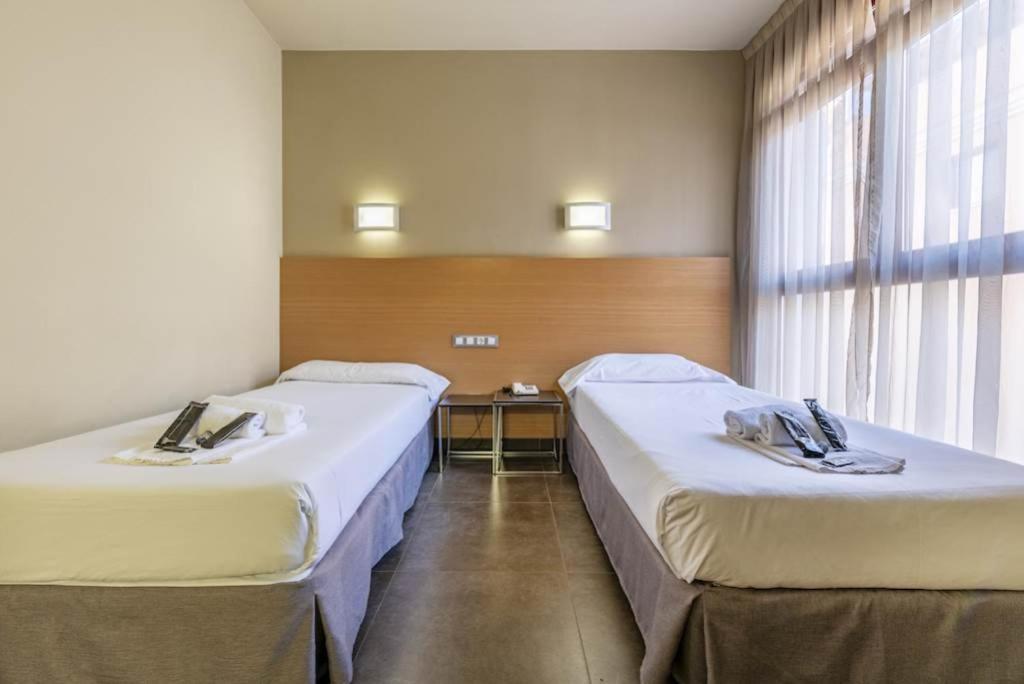 Postel nebo postele na pokoji v ubytování Hotel Pere III El Gran